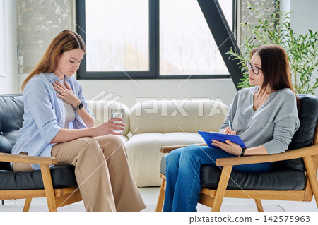 Individual psychological consultation, upset female patient with a professional therapist Individual psychological consultation, upset female patient with a professional therapist 142575963