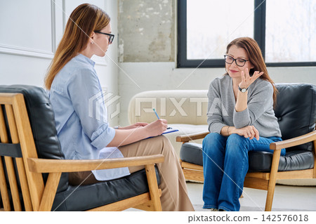Professional female psychologist or HR manager consulting middle-aged woman in office 142576018