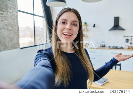 Selfie portrait happy beautiful young woman in home interior Selfie portrait happy beautiful young woman in home interior 142576144