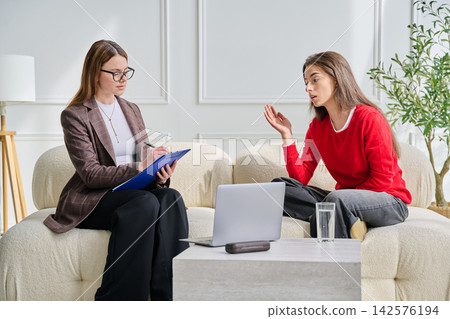 Teenage girl patient in therapy session with social mental therapist Teenage girl patient in therapy session with social mental therapist 142576194