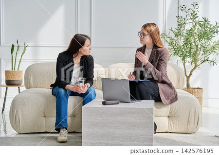 Sad mature woman in therapy with a psychologist Sad mature woman in therapy with a psychologist 142576195