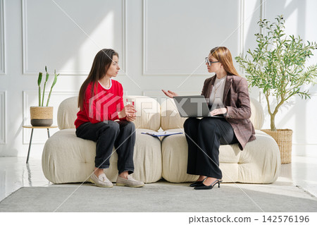 Sad teenage female patient in therapy session in psychologist office Sad teenage female patient in therapy session in psychologist office 142576196