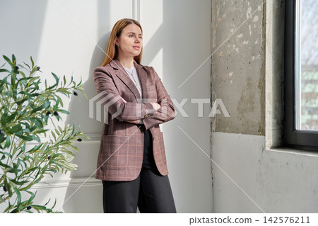 Portrait of young confident successful business woman with crossed arms Portrait of young confident successful business woman with crossed arms 142576211