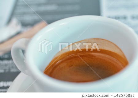 Close-up view of a white ceramic cup filled with fresh espresso coffee with crema Close-up view of a white ceramic cup filled with fresh espresso coffee with crema 142576885