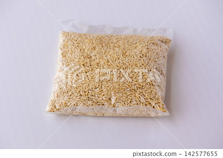 Dry handmade chutki pitha or semai pitha packed inside transparent plastic bag on white background. Traditional Bangladeshi rice flour pasta for sweet dessert. Dry handmade chutki pitha or semai pitha packed inside transparent plastic bag on white background. Traditional Bangladeshi rice flour pasta for sweet dessert. 142577655