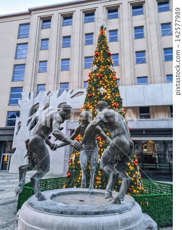 Old antique fountain iron sculpture of three "Dancing Fauns", Christmas tree in Gliwice, Poland Old antique fountain iron sculpture of three "Dancing Fauns", Christmas tree in Gliwice, Poland 142577989