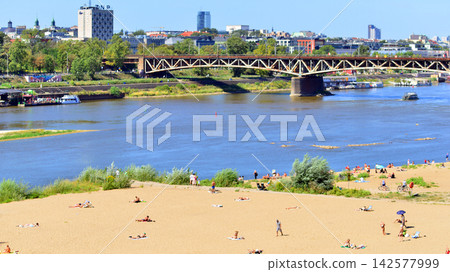 Warsaw, Poland. 15 August 2026. Stadium Beach (or Poniatowka beach) in the vicinity of the National Stadium. People sunbathe on the sandy beach. 142577999