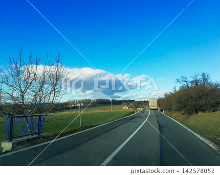Slovakian road trip in winter. Two lane highway with driving white truck Slovakian road trip in winter. Two lane highway with driving white truck 142578052