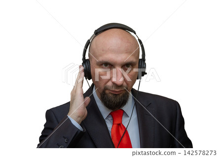 Serious bald businessman wearing headphones and listening on white background Serious bald businessman wearing headphones and listening on white background 142578273