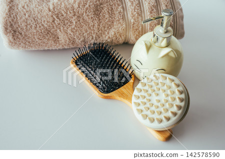 Cat soap dispenser close up with blur towel background. Close up of cute ceramic cat soap dispenser with chrome pump and blurred rolled towel in background, charming bathroom accessory detail for home Cat soap dispenser close up with blur towel background. Close up of cute ceramic cat soap dispenser with chrome pump and blurred rolled towel in background, charming bathroom accessory detail for home 142578590