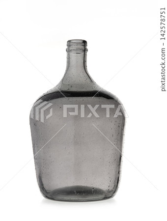 Empty vintage large grey glass bottle carboy isolated on white background with texture and small air bubbles inside Empty vintage large grey glass bottle carboy isolated on white background with texture and small air bubbles inside 142578751