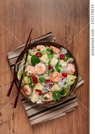 Thai salad with shrimp and rice noodles, pineapple slices, coriander and mint leaves, homemade , no people, 142579034