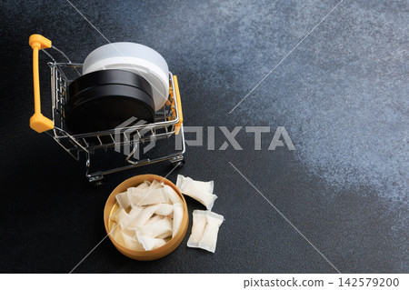 Exploration of snus pouches in a shopping cart with nicotine pads on a dark surface Exploration of snus pouches in a shopping cart with nicotine pads on a dark surface 142579200