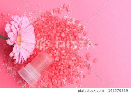 Natural crystal alum deodorant with pink salt crystals and a pink flower placed on a bright pink background Natural crystal alum deodorant with pink salt crystals and a pink flower placed on a bright pink background 142579219