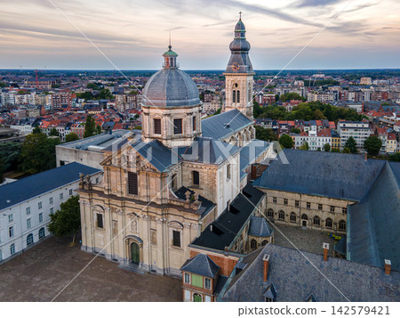 Saint Peters Church and Abbey at Sunset in Ghent. Aerial drone view of Saint Peter Church and abbey with the dome and tower above the rooftops of Ghent, Belgium at sunset, a scenic aerial of the histo 142579421