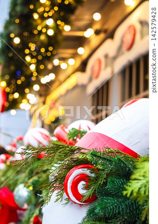 Decorations and lights at a holiday market in the evening during the Christmas season Decorations and lights at a holiday market in the evening during the Christmas season 142579428
