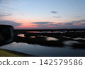 Venetian Lagoon sunset with pink clouds and water reflection 142579586
