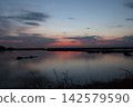 Venetian Lagoon sunset with pink clouds and water reflection 142579590