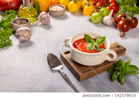 Fresh tomato soup with basil, garlic, and colorful vegetables Fresh tomato soup with basil, garlic, and colorful vegetables 142579619