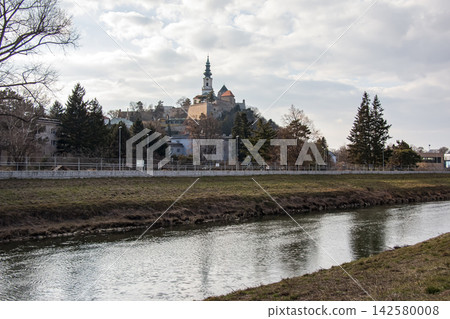 Nitra, Slovakia - March 1, 2025: Nitra Castle Seen Across the River Nitra, Slovakia - March 1, 2025: Nitra Castle Seen Across the River 142580008