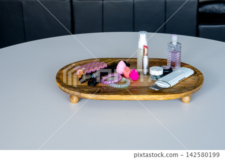 Makeup brushes and beauty sponge pink tones on wood surface. Makeup brushes and beauty blending sponges in pink tones arranged on rustic wood surface, feminine beauty tools for cosmetics application 142580199