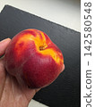 Ripe Peach Ready for a Tasty Bite in a Cozy Kitchen Setting 142580548