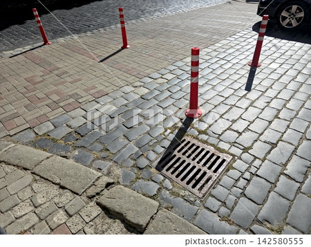 Bright Red Road Signal Posts Marking the Pavement in an Urban Area 142580555