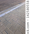 Clear Road Markings Guide Pedestrians Along a Newly Paved Sidewalk 142580558