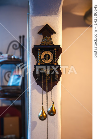 Vintage Wooden Wall Clock. Rustic old wall clock made of wood, reflecting timeless antique style and elegance. Vintage Wooden Wall Clock. Rustic old wall clock made of wood, reflecting timeless antique style and elegance. 142580648