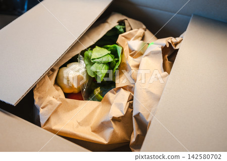 Eco Bag with Fresh Groceries. Reusable eco bag filled with fresh vegetables and fruits placed on a kitchen counter. Healthy, sustainable shopping concept. Eco Bag with Fresh Groceries. Reusable eco bag filled with fresh vegetables and fruits placed on a kitchen counter. Healthy, sustainable shopping concept. 142580702