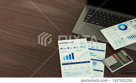 Business Reports with Laptop and Calculator on Wooden Office Desk 3d render. Business Reports with Laptop and Calculator on Wooden Office Desk 3d render. 142581282