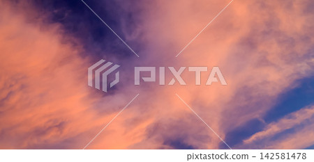 vivid pink and orange clouds in blue sky vivid pink and orange clouds in blue sky 142581478