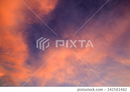 bright orange and purple clouds in the sunset sky with soft light transitions bright orange and purple clouds in the sunset sky with soft light transitions 142581482