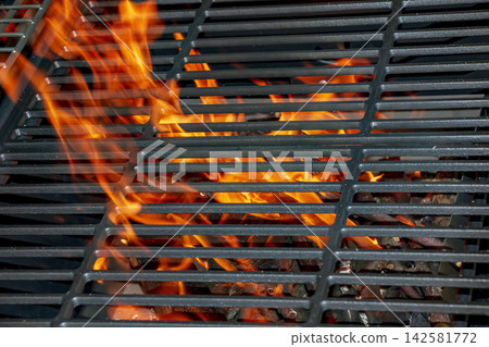 Charcoal Fire Heating Metal Grate in Outdoor Barbecue Grill Charcoal Fire Heating Metal Grate in Outdoor Barbecue Grill 142581772