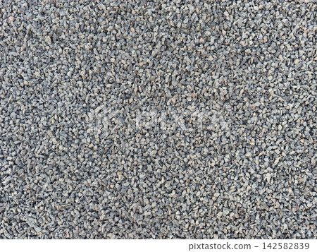 Closeup gray gravel surface showing coarse angular stones and textured speckled pattern for landscaping and construction applications, with gravel, texture, surface, gray detail Closeup gray gravel surface showing coarse angular stones and textured speckled pattern for landscaping and construction applications, with gravel, texture, surface, gray detail 142582839