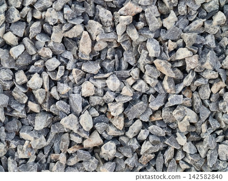 Closeup gray gravel stones texture for construction landscaping pathways foundation aggregate bed showing rough fragmented rocks, with gravel, stone, rock, crushed detail Closeup gray gravel stones texture for construction landscaping pathways foundation aggregate bed showing rough fragmented rocks, with gravel, stone, rock, crushed detail 142582840