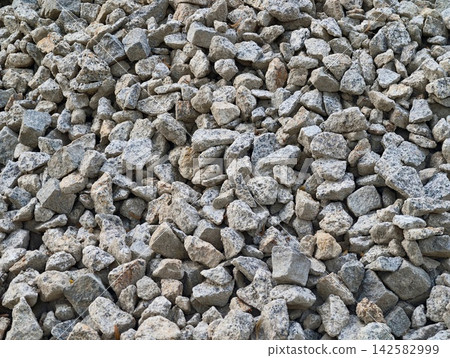 Dense pile of loose gray gravel rocks with rough textured stones for construction, driveways, landscaping, drainage, and rugged outdoor ground surfaces, with gravel, rock, stone, pile detail Dense pile of loose gray gravel rocks with rough textured stones for construction, driveways, landscaping, drainage, and rugged outdoor ground surfaces, with gravel, rock, stone, pile detail 142582999