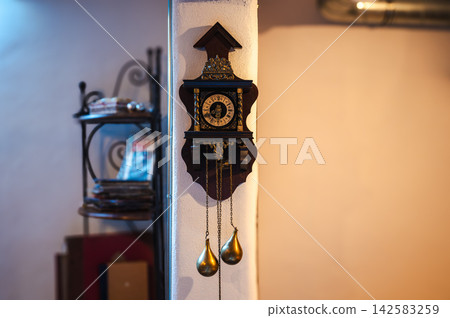 Old Style Wall Clock. Vintage wall clock with classic design, showing traditional craftsmanship and nostalgic aesthetics. Old Style Wall Clock. Vintage wall clock with classic design, showing traditional craftsmanship and nostalgic aesthetics. 142583259