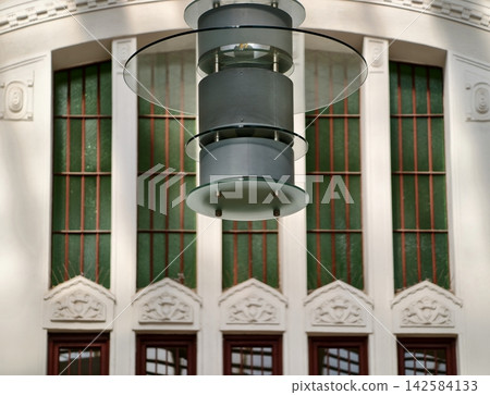 Spacious interior with prominent pendant lighting and arched greenmuntin windows for formal events Spacious interior with prominent pendant lighting and arched greenmuntin windows for formal events 142584133