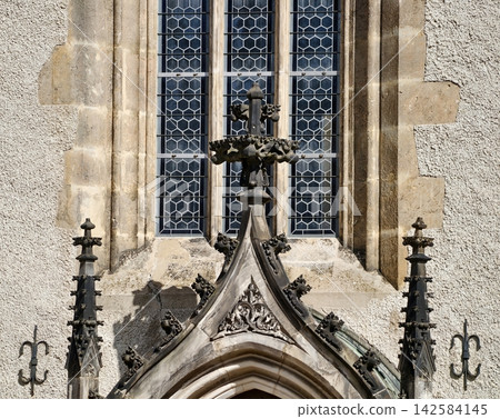 Historic stone arch emphasizing intricate cross design and sunlit textured masonry for preservation purposes Historic stone arch emphasizing intricate cross design and sunlit textured masonry for preservation purposes 142584145