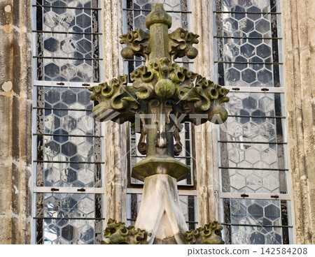 Old stone water feature. Scene showing mosscovered fountain with stained glass window in background Old stone water feature. Scene showing mosscovered fountain with stained glass window in background 142584208