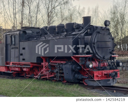 Detailed view of classic steam locomotive featuring lighting and industrial design elements Detailed view of classic steam locomotive featuring lighting and industrial design elements 142584219