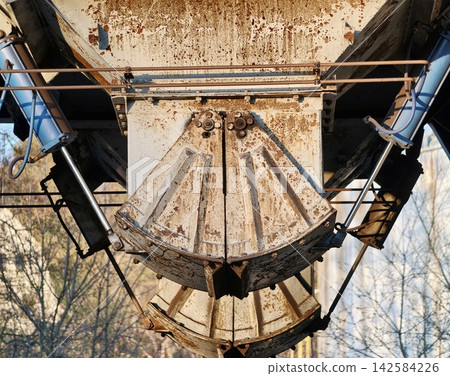 Detailed shot of deteriorated industrial equipment illuminated by soft warm workshop lighting Detailed shot of deteriorated industrial equipment illuminated by soft warm workshop lighting 142584226