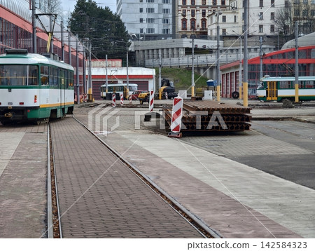 Construction zone with safety measures. Steel plates and building supplies situated near railway tracks Construction zone with safety measures. Steel plates and building supplies situated near railway tracks 142584323