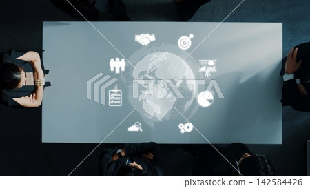 Aerial View of Business Meeting with World Globe Projection on Table and Diverse Professionals Engaged in Discussion and Collaboration. Raster Aerial View of Business Meeting with World Globe Projection on Table and Diverse Professionals Engaged in Discussion and Collaboration. Raster 142584426