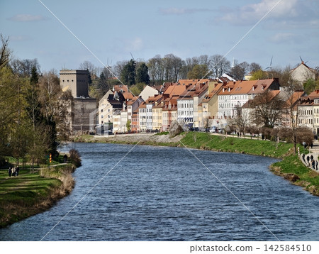 Colorful town by winding river. Peaceful landscape of historic town with scenic waterside views Colorful town by winding river. Peaceful landscape of historic town with scenic waterside views 142584510