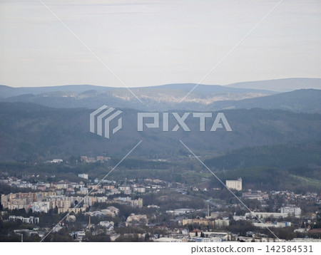 Valley with town. Remote landscape with residential clusters and industrial scattered sites Valley with town. Remote landscape with residential clusters and industrial scattered sites 142584531