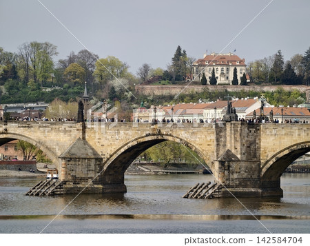 Historic stone arch spans water. Morning mist envelops serene river and majestic stone structure Historic stone arch spans water. Morning mist envelops serene river and majestic stone structure 142584704
