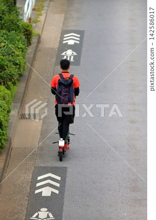 Image of an electric kickboard running on the road Image of an electric kickboard running on the road 142586017