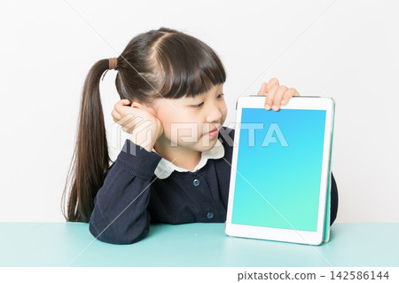 Smiling Asian school girl showing tablet with blank screen, digital learning and education technology concept, studio isolated on white background Smiling Asian school girl showing tablet with blank screen, digital learning and education technology concept, studio isolated on white background 142586144